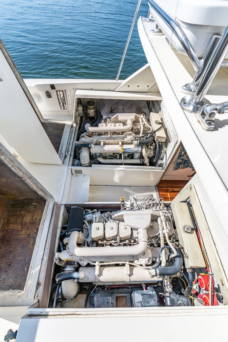 Slide: The Image of Engine compartment of a 1979 Bertram Flybridge Cruiser with two engines, surrounded by water. - 47