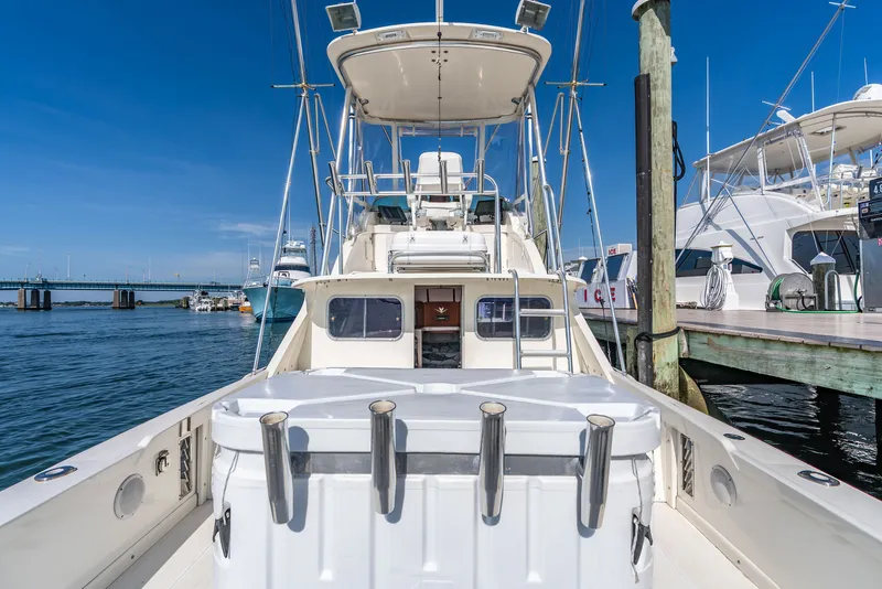 Slide: The Image of 1979 Bertram Flybridge Cruiser docked with a clear view of the helm. - 7
