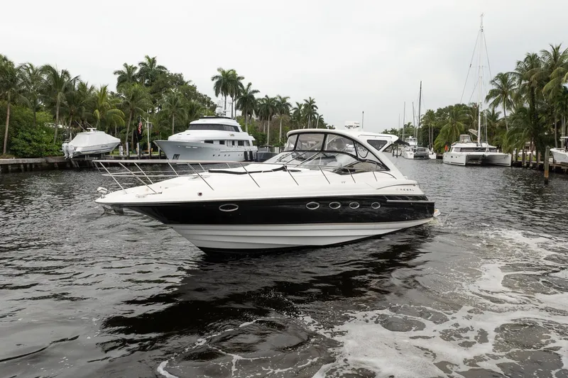 Slide: The Image of 2008 Regal Commodore 4460 yacht cruising in a tropical marina with palm trees. - 5