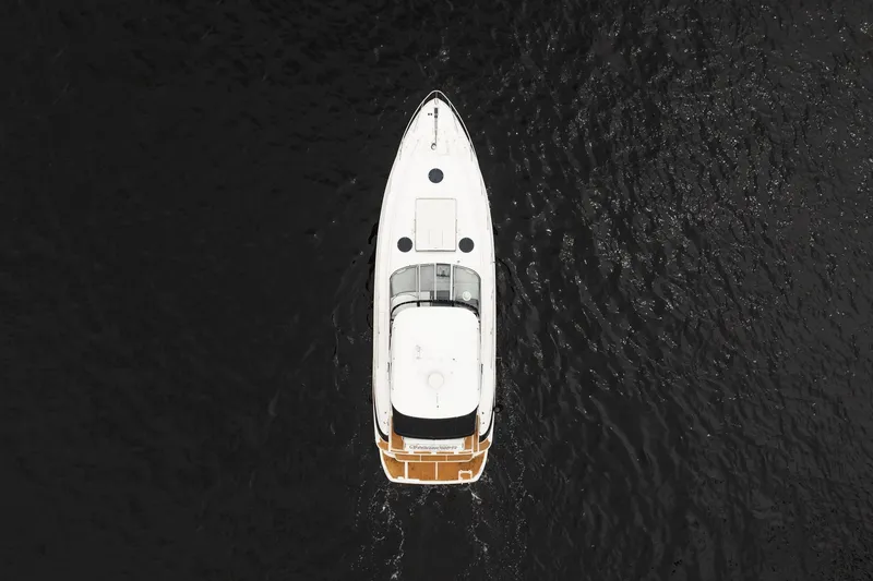 Slide: The Image of Aerial view of 2008 Regal Commodore 4460 yacht on dark water. - 22