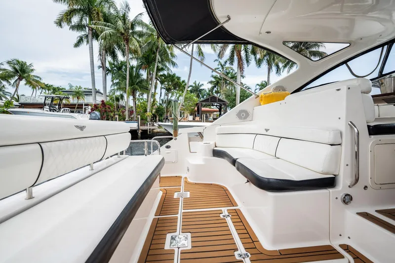 Slide: The Image of Luxurious 2008 Regal Commodore 4460 yacht interior with white seating and teak flooring. - 86