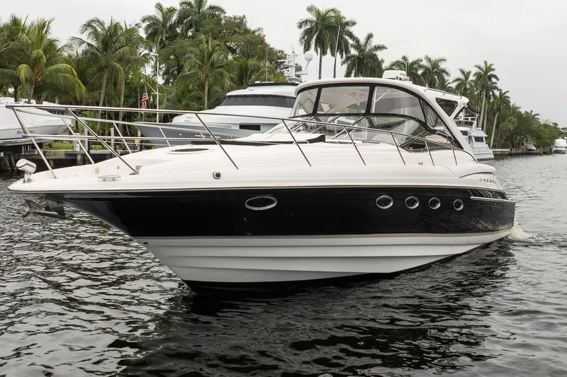 Slide: The Image of 2008 Regal Commodore 4460 yacht cruising on a tropical waterway with palm trees. - 19