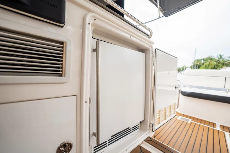 Slide: The Image of 2008 Regal Commodore 4460 yacht interior with open cabinet and teak flooring. - 90