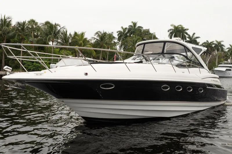 Slide: The Image of 2008 Regal Commodore 4460 yacht on water, surrounded by palm trees. - 17
