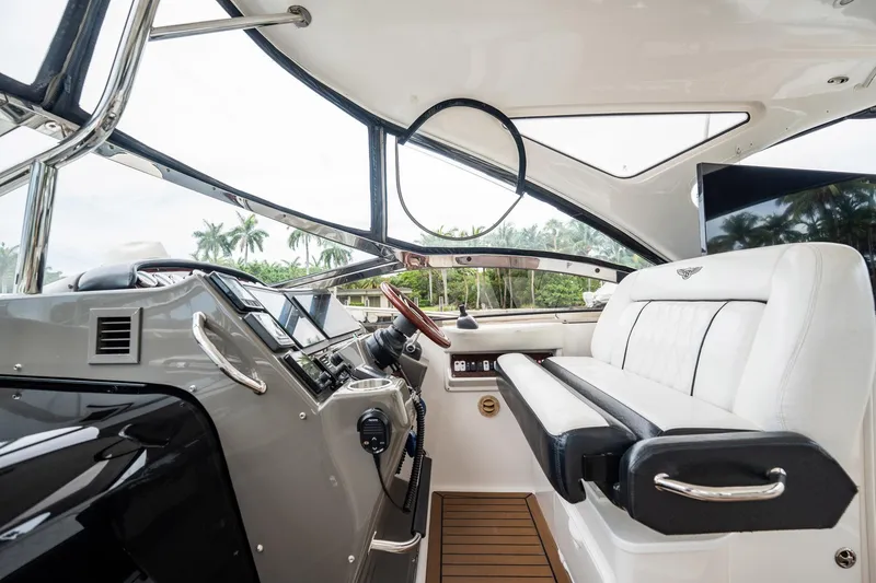Slide: The Image of Interior of 2008 Regal Commodore 4460 yacht with modern helm and luxurious seating. - 76