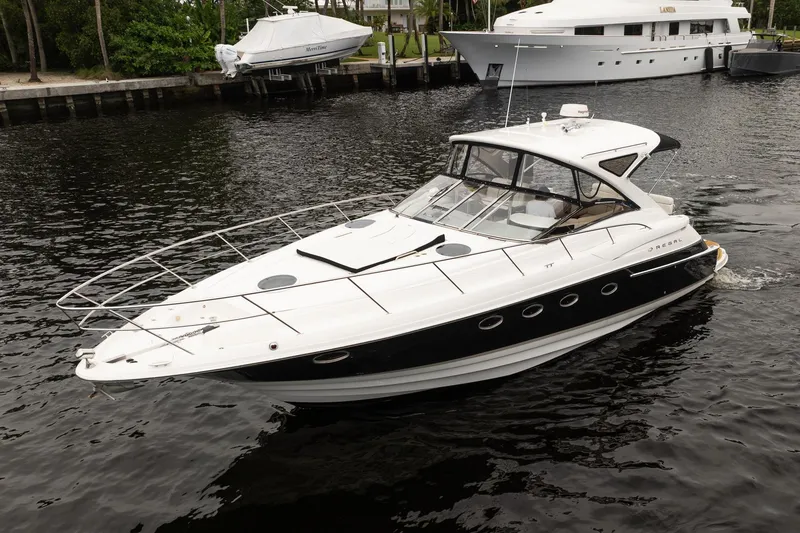 Slide: The Image of 2008 Regal Commodore 4460 yacht cruising on a calm waterway. - 14