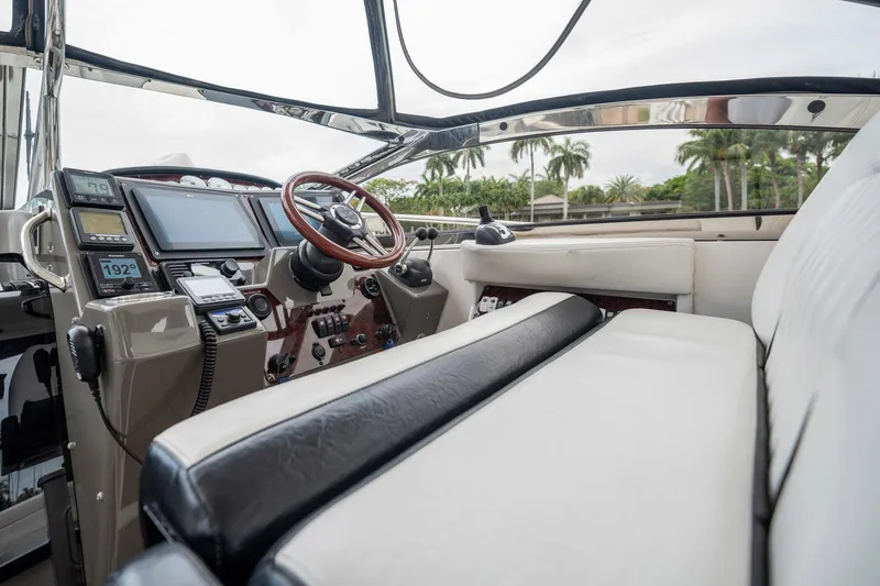 Slide: The Image of 2008 Regal Commodore 4460 yacht cockpit with leather seating and modern navigation controls. - 79