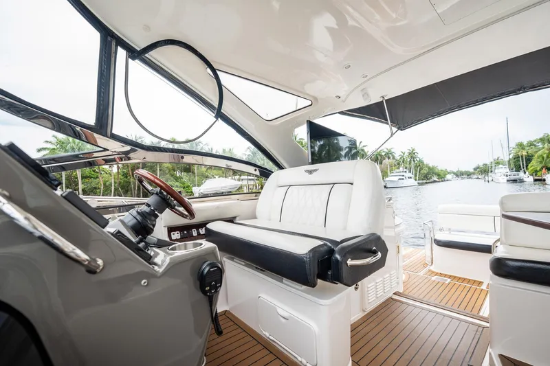 Slide: The Image of Luxurious interior of 2008 Regal Commodore 4460 yacht with elegant seating and scenic waterway view. - 77