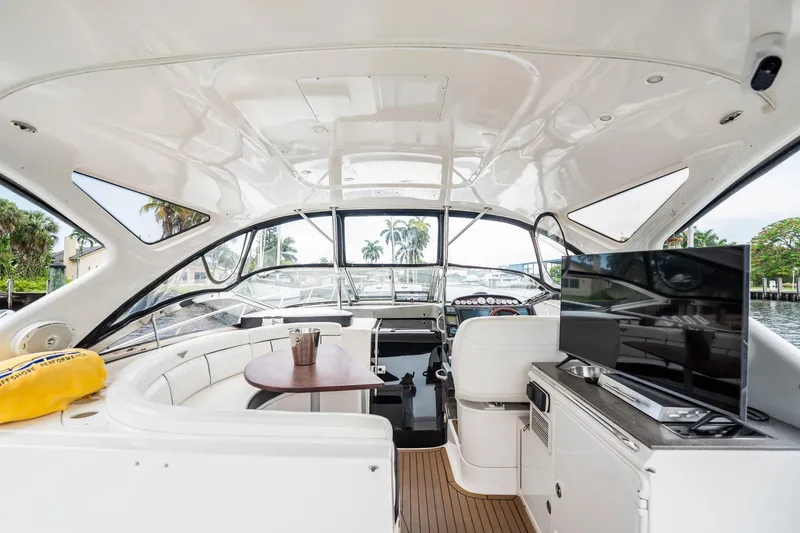 Slide: The Image of Luxurious 2008 Regal Commodore 4460 yacht interior with seating, table, and TV. - 85
