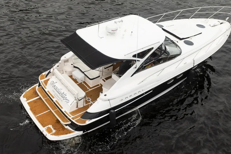Slide: The Image of 2008 Regal Commodore 4460 yacht on water, featuring sleek design and spacious deck. - 24