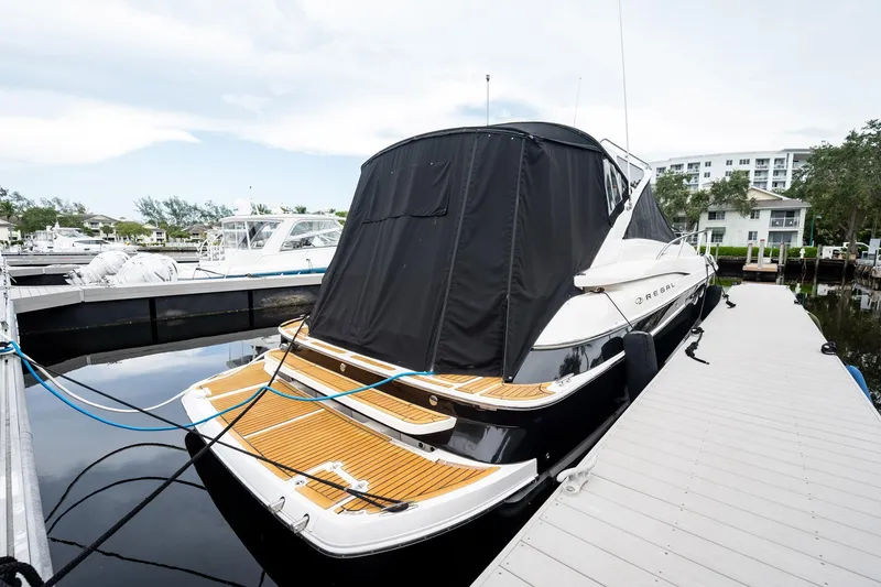 Slide: The Image of 2008 Regal Commodore 4460 yacht docked at marina with covered deck. - 25