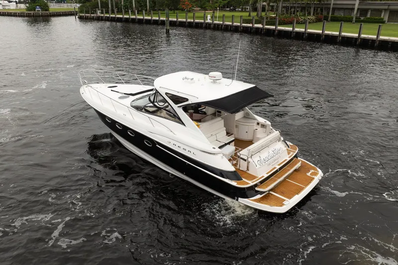 Slide: The Image of 2008 Regal Commodore 4460 yacht cruising on a calm waterway. - 9