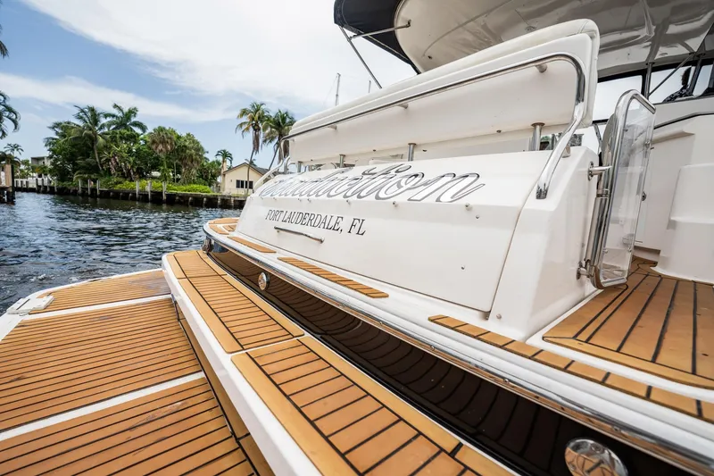 Slide: The Image of 2008 Regal Commodore 4460 yacht docked in Fort Lauderdale, featuring teak decking. - 70