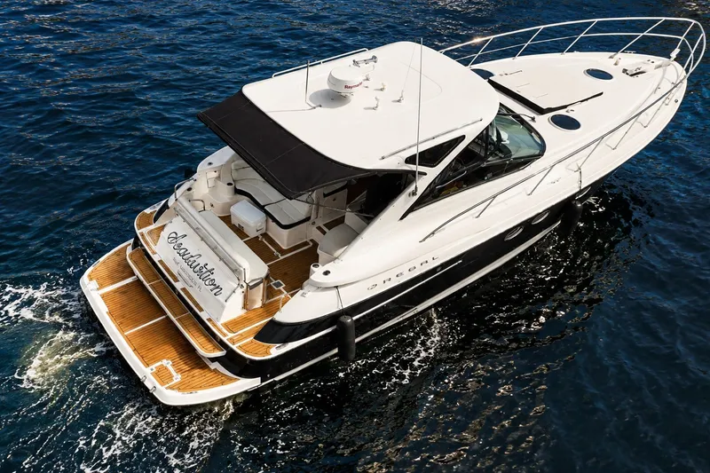 Slide: The Image of 2008 Regal Commodore 4460 yacht cruising on open water, featuring sleek design and spacious deck. - 101
