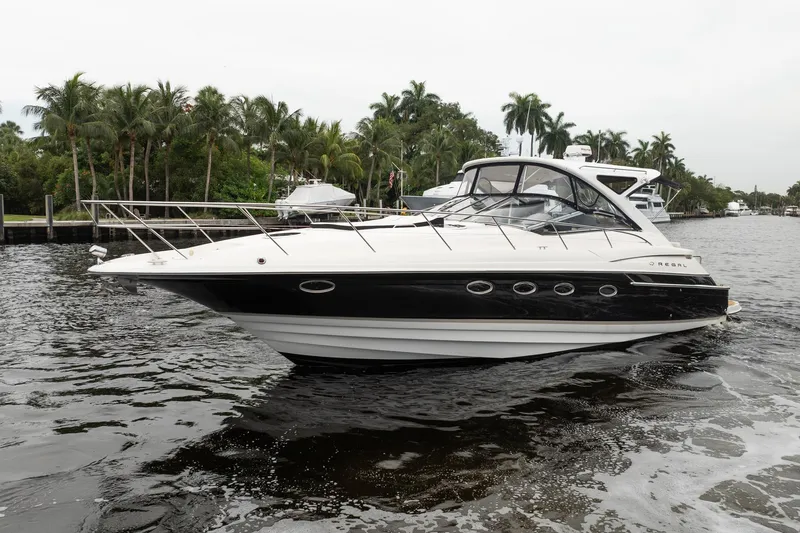 Slide: The Image of 2008 Regal Commodore 4460 yacht cruising on a scenic waterway with lush palm trees. - 6