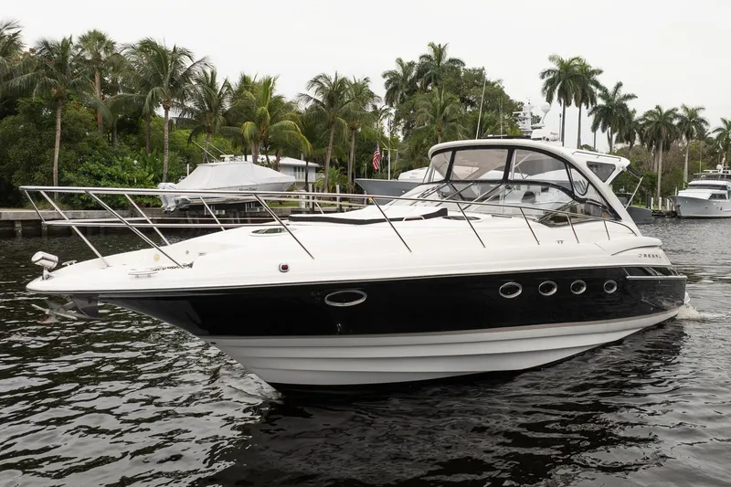 Slide: The Image of 2008 Regal Commodore 4460 yacht cruising on a tropical waterway with palm trees. - 15