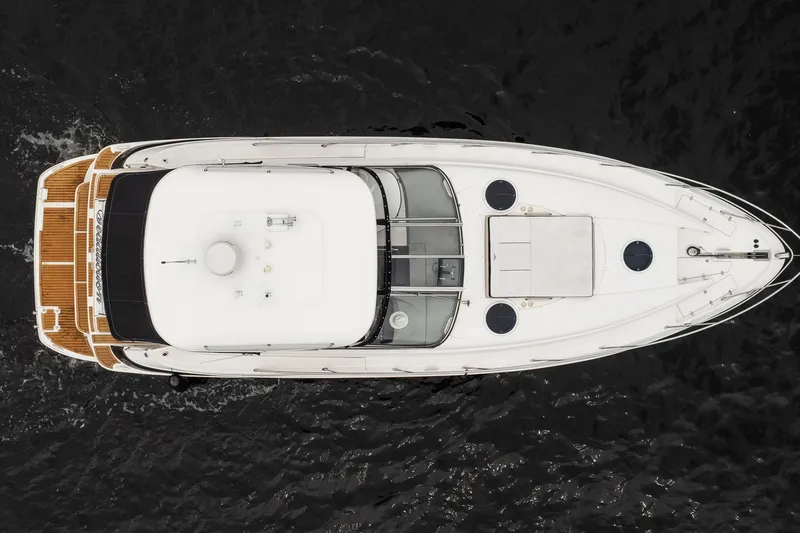 Slide: The Image of Overhead view of 2008 Regal Commodore 4460 yacht on dark water. - 23