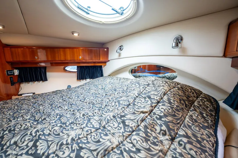 Slide: The Image of Luxurious cabin interior of 2008 Regal Commodore 4460 yacht with elegant bedding and wood accents. - 34