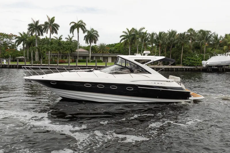 Slide: The Image of 2008 Regal Commodore 4460 yacht cruising on a tropical waterway with palm trees. - 8