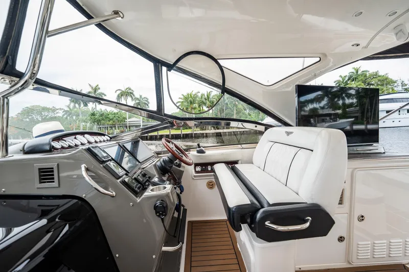 Slide: The Image of Luxurious 2008 Regal Commodore 4460 yacht interior with helm, seating, and waterfront view. - 75