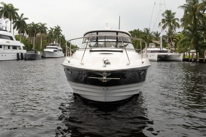 Slide: The Image of 2008 Regal Commodore 4460 yacht docked in a marina with palm trees. - 18