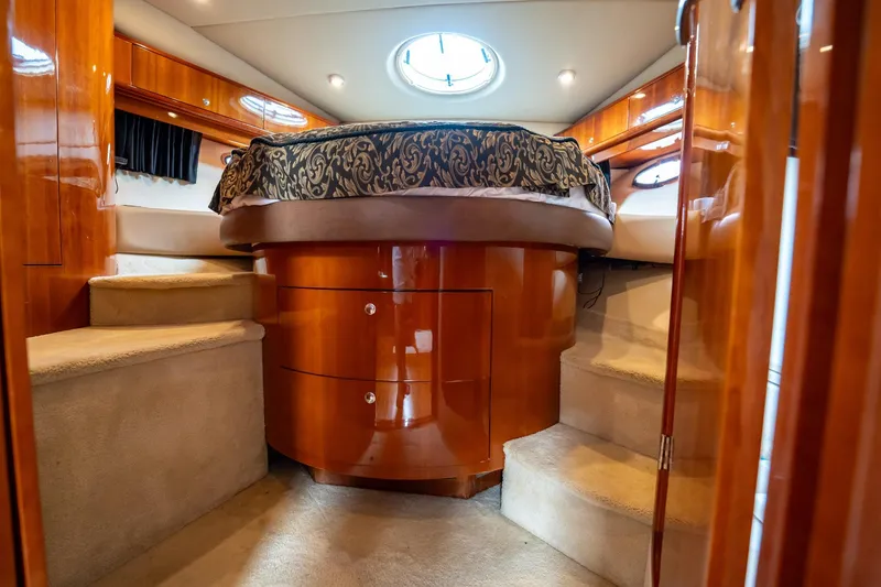 Slide: The Image of Luxurious 2008 Regal Commodore 4460 yacht interior with elegant wood finish and cozy bedding. - 37