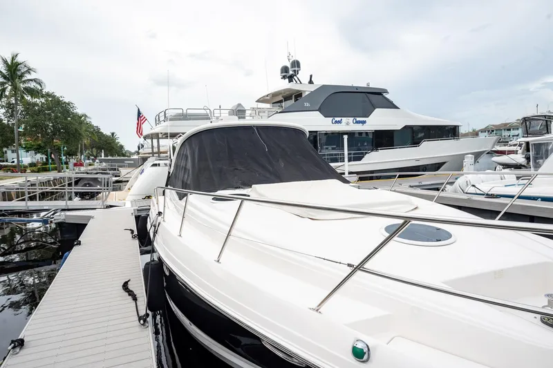 Slide: The Image of 2008 Regal Commodore 4460 yacht docked at marina with American flag in background. - 28