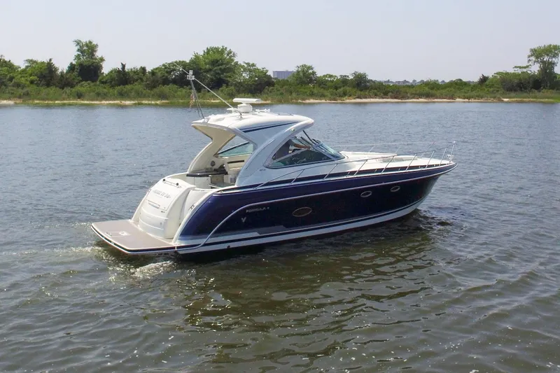 Slide: The Image of 2016 Formula 40 Performance Cruiser on calm water, showcasing sleek design and luxury features. - 4