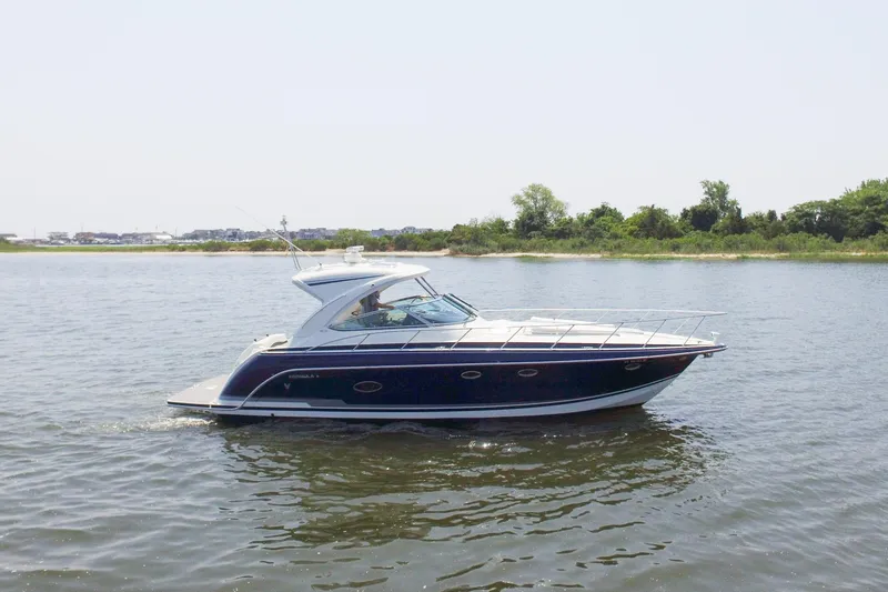 Slide: The Image of 2016 Formula 40 Performance Cruiser on calm water near shoreline. - 3