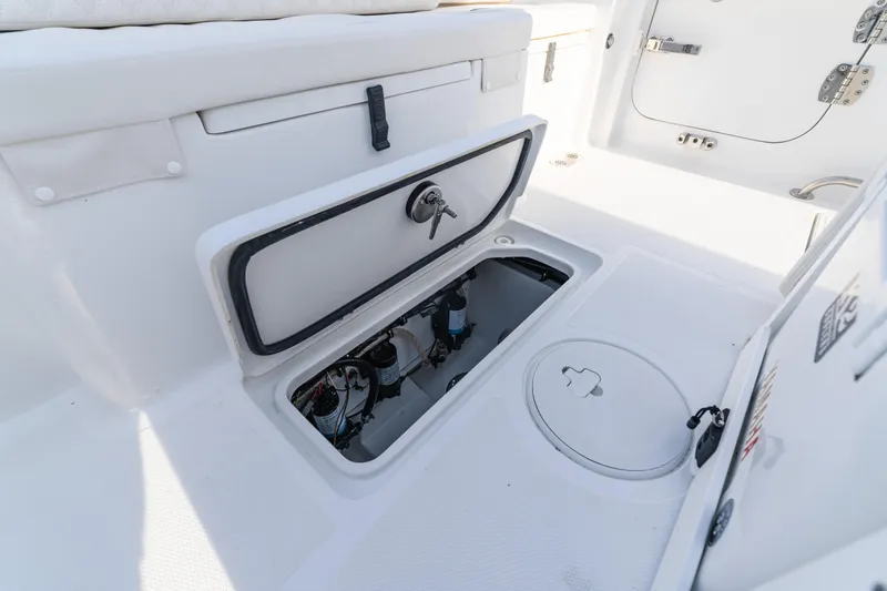 Slide: The Image of Open storage compartment on 2027 Sea Hunt Ultra 275 SE boat deck. - 21