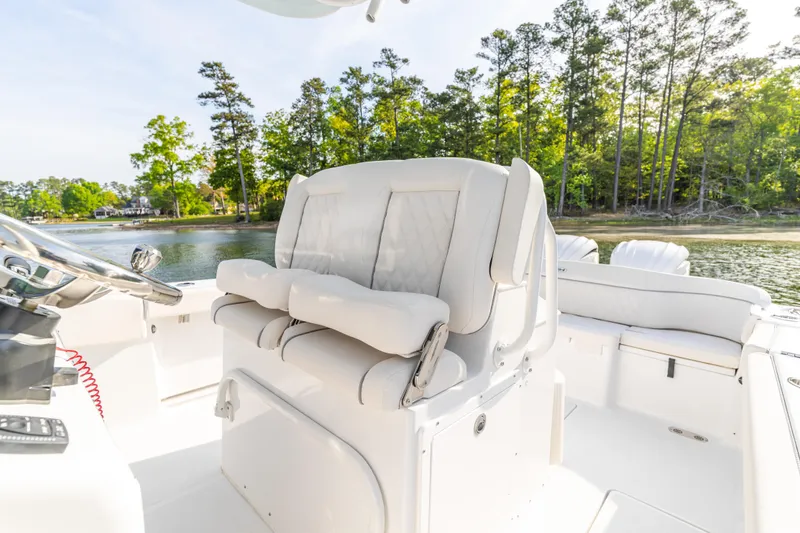 Slide: The Image of Luxurious seating on 2027 Sea Hunt Ultra 275 SE boat, surrounded by serene waters and lush trees. - 24