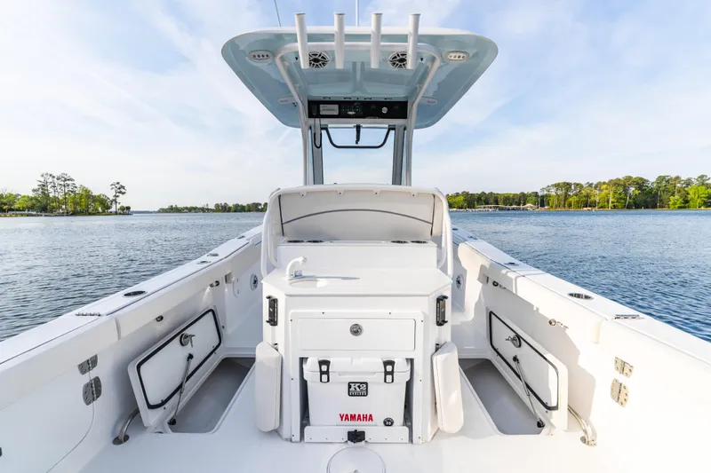 Slide: The Image of 2027 Sea Hunt Ultra 275 SE boat interior with Yamaha cooler on calm water. - 19