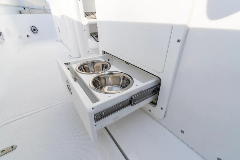 Slide: The Image of 2027 Sea Hunt Ultra 275 SE boat with built-in drawer featuring dual stainless steel bowls. - 23