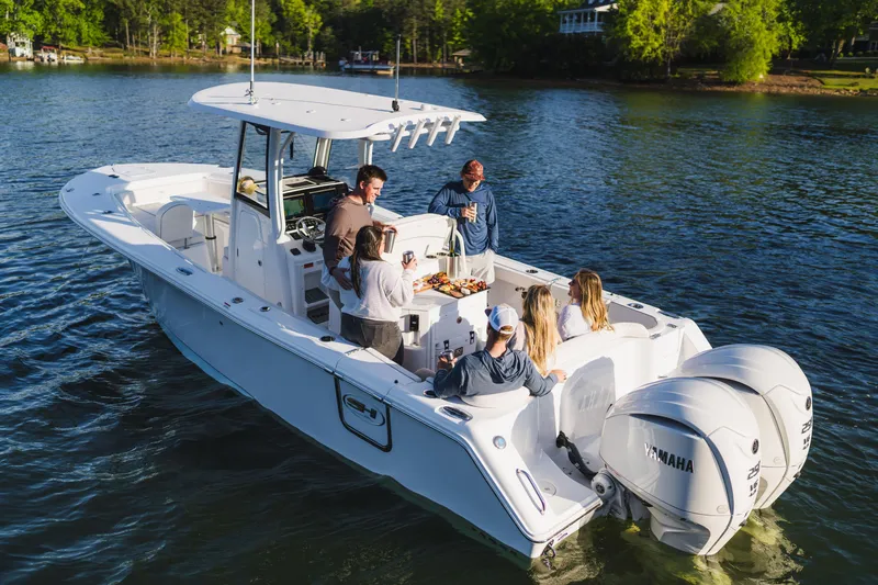 Slide: The Image of 2027 Sea Hunt Ultra 275 SE boat with people enjoying a sunny day on the water. - 2