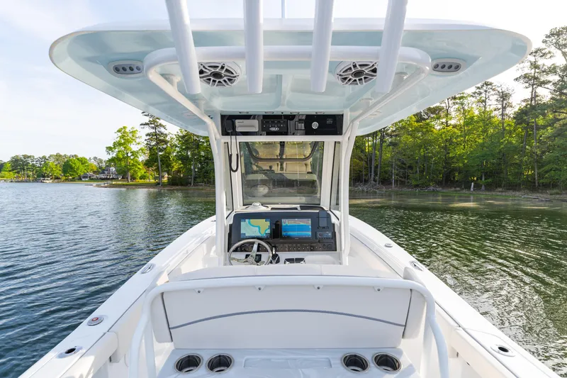 Slide: The Image of 2027 Sea Hunt Ultra 275 SE boat interior with advanced navigation system on a serene lake. - 14