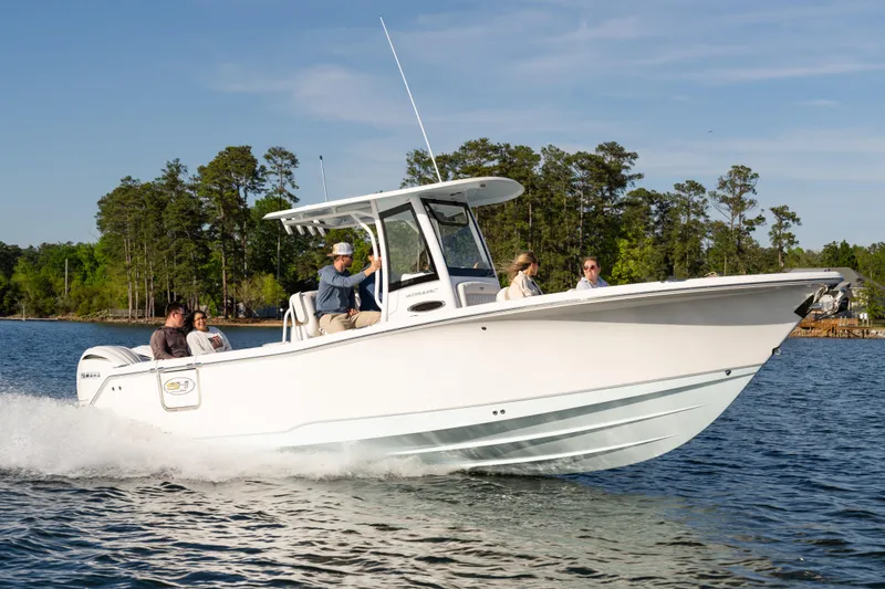 Slide: The Image of 2027 Sea Hunt Ultra 275 SE boat cruising on a lake with passengers onboard. - 28
