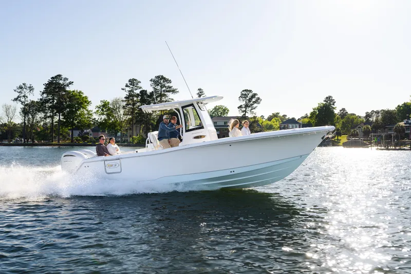 Slide: The Image of 2027 Sea Hunt Ultra 275 SE cruising on a sunny lake with passengers onboard. - 27