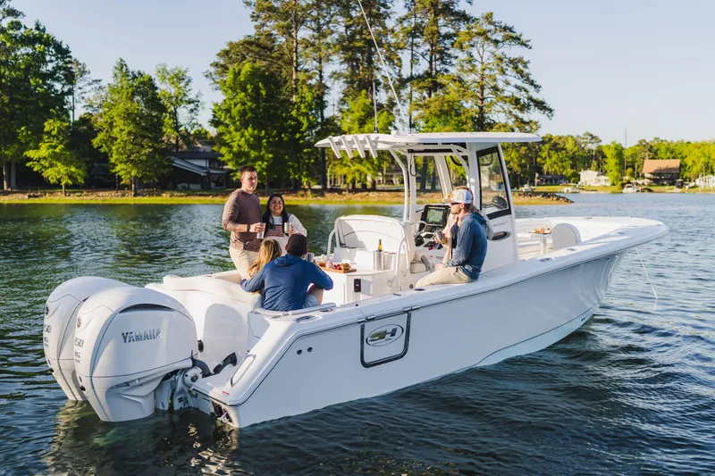 Slide: The Image of 2027 Sea Hunt Ultra 275 SE boat with people enjoying a sunny day on the water. - 29