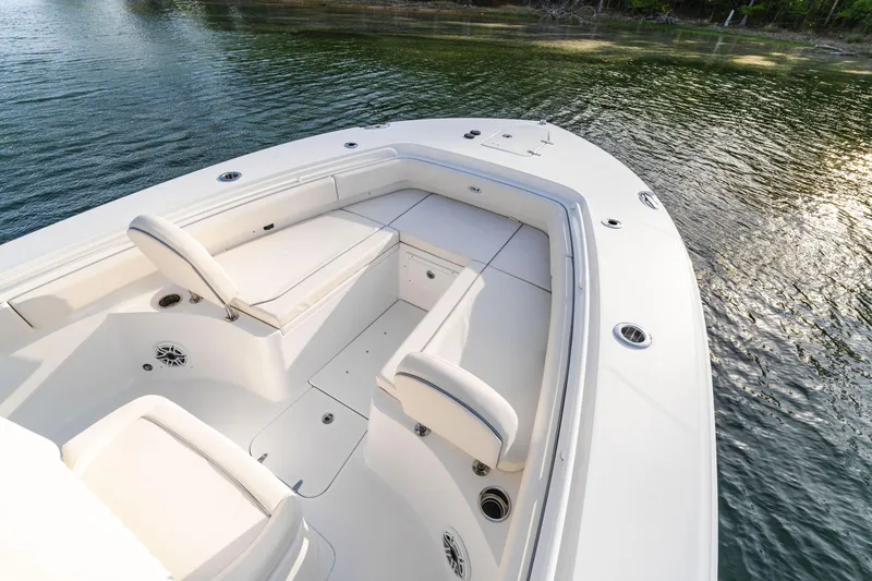 Slide: The Image of 2027 Sea Hunt Ultra 275 SE boat with spacious seating on calm water. - 13