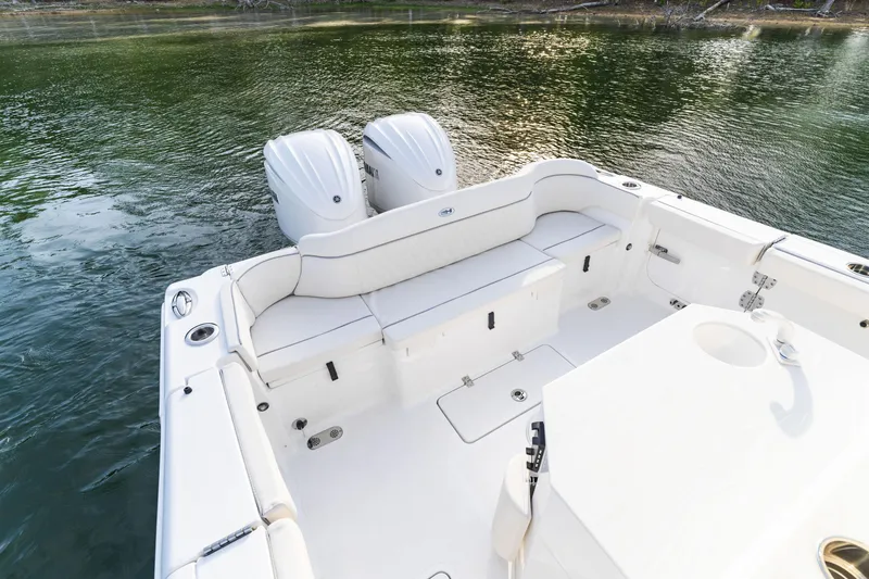 Slide: The Image of 2027 Sea Hunt Ultra 275 SE boat with dual engines on calm water. - 17