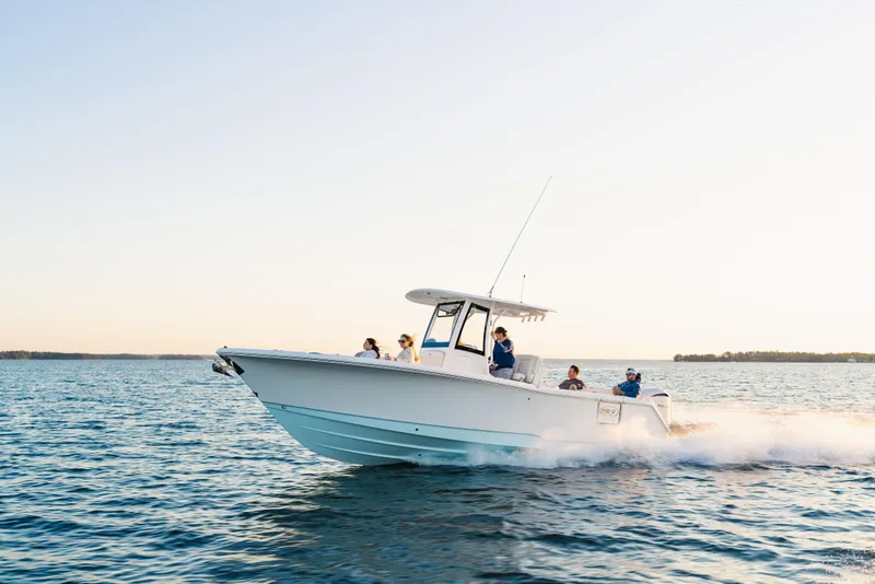 Slide: The Image of 2027 Sea Hunt Ultra 275 SE cruising on open water at sunset. - 31