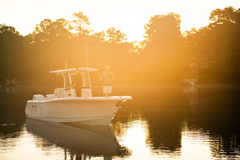 Slide: The Image of Sea Hunt Ultra 275 SE boat on serene water at sunrise, 2027 model. - 4
