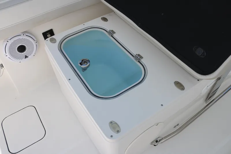 Slide: The Image of Livewell on 2026 World Cat 280 DC-X boat, featuring a speaker and storage compartment. - 13