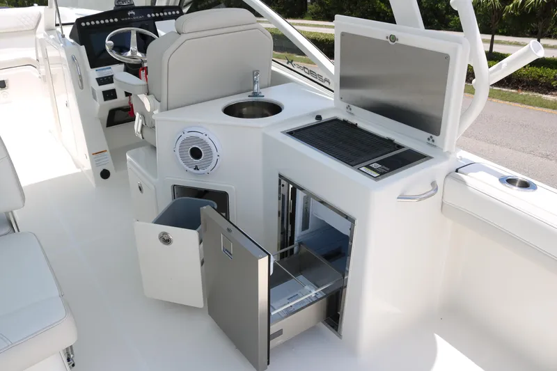 Slide: The Image of Interior of 2026 World Cat 280 DC-X boat featuring helm, sink, and storage compartments. - 12