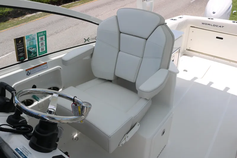 Slide: The Image of 2026 World Cat 280 DC-X boat helm with white captain's chair and steering wheel. - 10