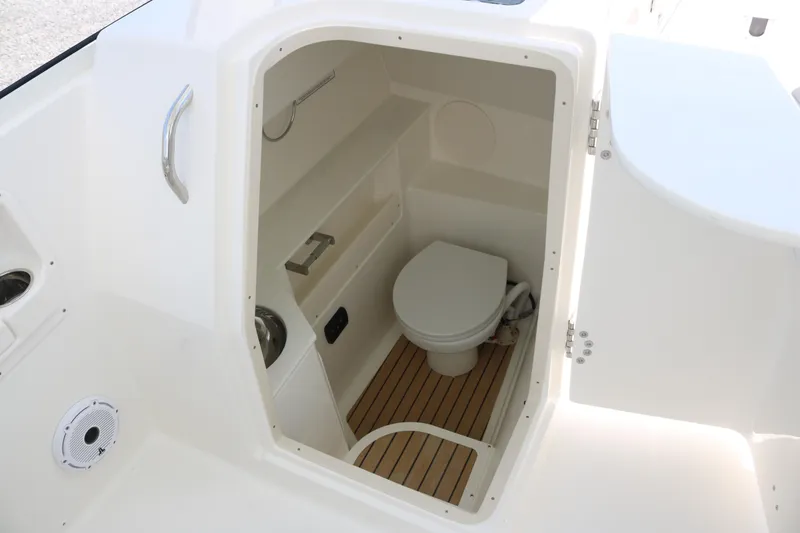 Slide: The Image of Interior view of 2026 World Cat 280 DC-X boat's compact bathroom with toilet. - 8