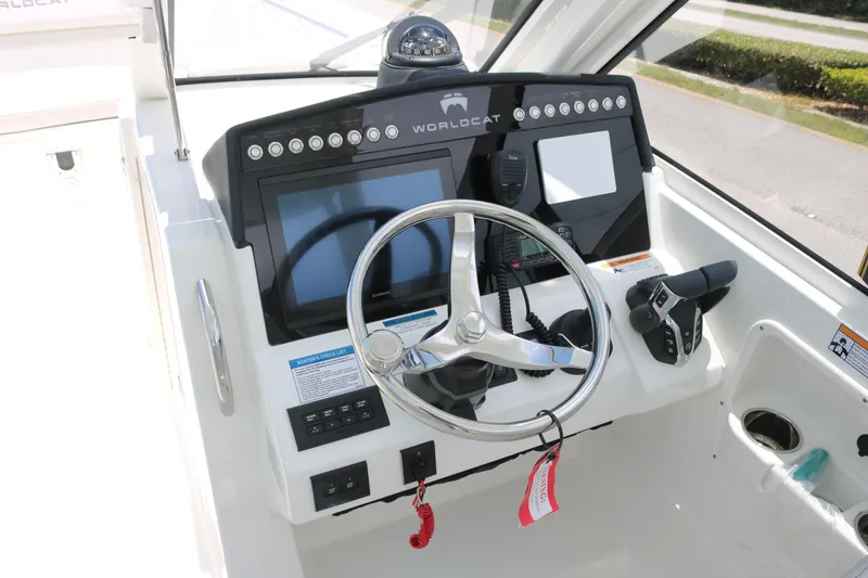 Slide: The Image of Cockpit of 2026 World Cat 280 DC-X boat with steering wheel and controls. - 9