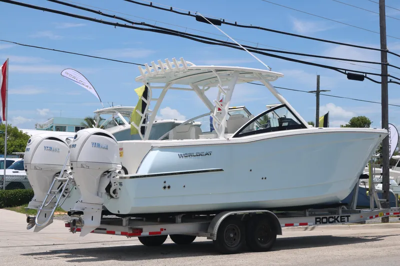 Slide: The Image of 2026 World Cat 280 DC-X boat on trailer, featuring dual Yamaha engines. - 3