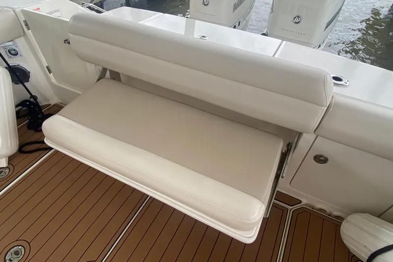 Slide: The Image of 2016 Boston Whaler 330 Outrage boat seat with teak flooring and dual Mercury engines. - 15