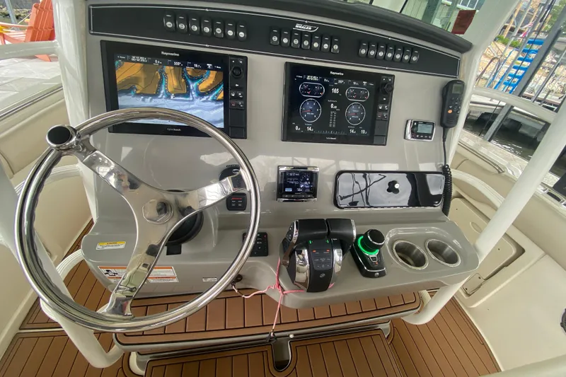 Slide: The Image of Helm of 2016 Boston Whaler 330 Outrage with advanced navigation and control systems. - 16